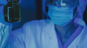 Young scientists conducting research investigations in a medical laboratory, a researcher in the foreground is using a microscope video