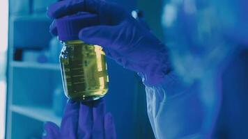 Young scientists conducting research investigations in a medical laboratory, a researcher in the foreground is using a microscope video