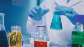 Young scientists conducting research investigations in a medical laboratory, a researcher in the foreground is using a microscope video