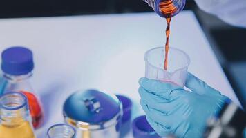 Young scientists conducting research investigations in a medical laboratory, a researcher in the foreground is using a microscope video