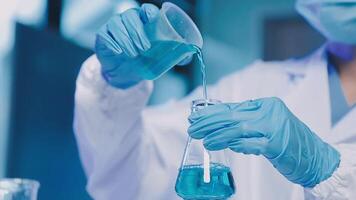 Young scientists conducting research investigations in a medical laboratory, a researcher in the foreground is using a microscope video