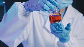 Young scientists conducting research investigations in a medical laboratory, a researcher in the foreground is using a microscope video