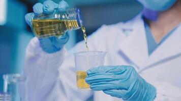 Young scientists conducting research investigations in a medical laboratory, a researcher in the foreground is using a microscope video