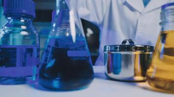 Young scientists conducting research investigations in a medical laboratory, a researcher in the foreground is using a microscope video