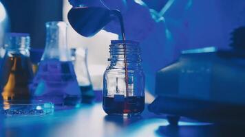 Young scientists conducting research investigations in a medical laboratory, a researcher in the foreground is using a microscope video