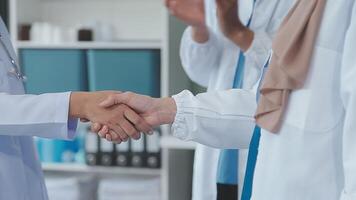 another member joining the team. Shot of two doctors shaking hands in a meeting at a hospital. video