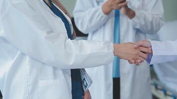 another member joining the team. Shot of two doctors shaking hands in a meeting at a hospital. video