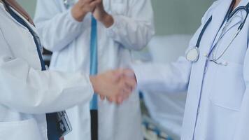 another member joining the team. Shot of two doctors shaking hands in a meeting at a hospital. video