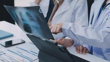 Qualified woman doctor in white uniform checking x-ray film, diagnose patient injury, smiling calm and standing isolated on studio background with copy space. Healthcare and medical insurance concept video