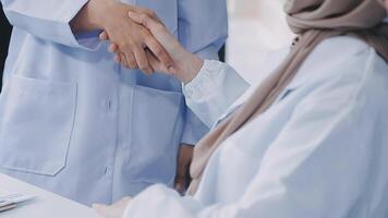 another member joining the team. Shot of two doctors shaking hands in a meeting at a hospital. video