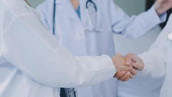 another member joining the team. Shot of two doctors shaking hands in a meeting at a hospital. video