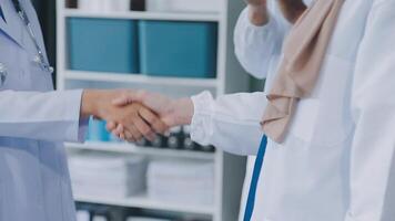 another member joining the team. Shot of two doctors shaking hands in a meeting at a hospital. video