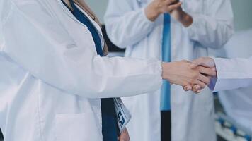 another member joining the team. Shot of two doctors shaking hands in a meeting at a hospital. video