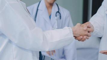 another member joining the team. Shot of two doctors shaking hands in a meeting at a hospital. video