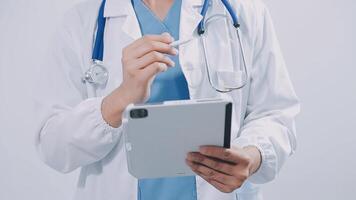 Doctor using digital tablet find information patient medical history at the hospital. Medical technology concept. video