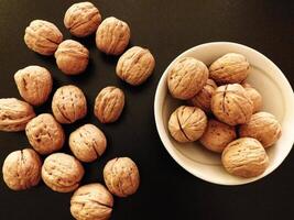 Walnuts in shell on wooden background video