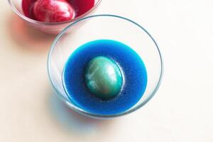 festive painted Easter eggs with colorful dyes on the table at home. photo