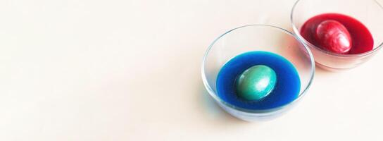 festive painted Easter eggs with colorful dyes on the table at home. photo