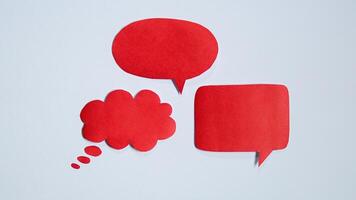 Red paper speech bubble on white background. Blank space that can be added text. photo