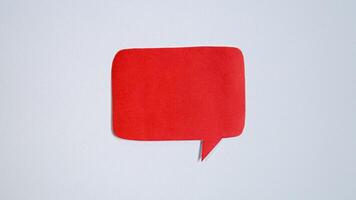 Red paper speech bubble on white background. Blank space that can be added text. photo