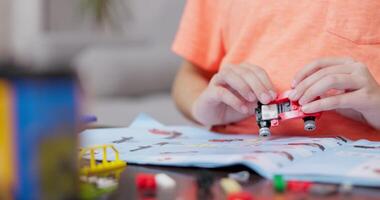 Child Assembling Toy Car with Building Bricks video