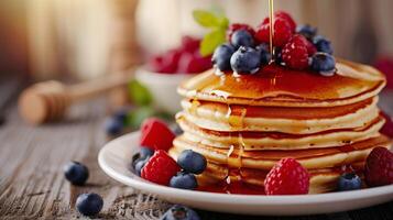 AI Generated Fluffy pancakes topped with blueberries, raspberries, and a drizzle of honey or maple syrup photo