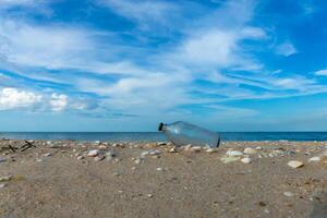 Glass bottles on the beach photo