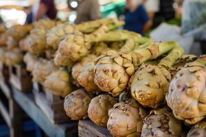 AI generated Stack of artichokes on a market stall. photo
