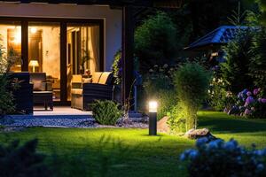 AI generated Light posts illuminated backyard garden during night hours. Modern backyard outdoor lighting systems. photo