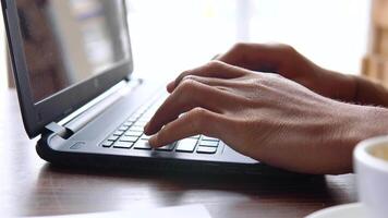 Man typing text on laptop keyboard. Close-up view of hands video