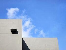 Minimal Building with White Cloud and Blue Sky Background. photo