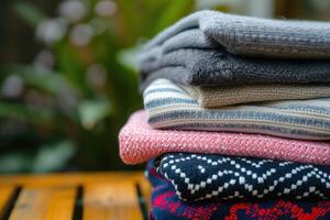 AI generated Pile of knitted sweaters as background, closeup view photo