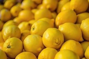 AI generated Ripe yellow lemons close up or texture. Lemon harvest, many yellow lemons. photo