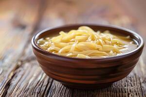 AI generated Bowl of chicken noodle soup on a wooden table. photo