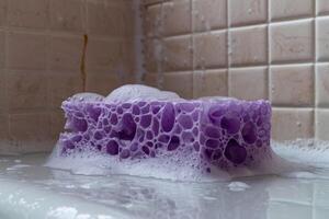 AI generated Wet purple sponge in bathroom. photo