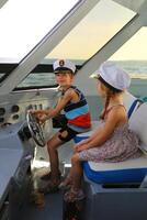 Portrait of children driving a yacht photo