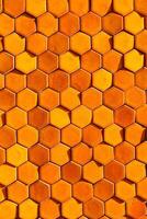 Bright orange sunlit hexagonal honeycomb tile background photo