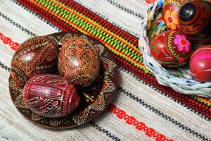 Traditional authentic ukrainian painted Easter eggs on traditional embroidered napkin or table cloth rushnyk photo