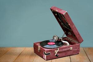 Old vintage gramophone player with a vinyl record and negative space photo