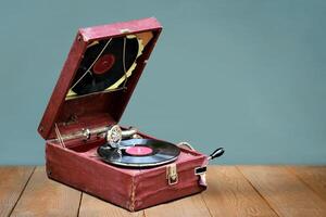 Old vintage gramophone player with a vinyl record and negative space photo