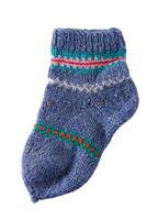 Knitting socks from woolen threads. Handmade cozy homemade warm winter colorful striped socks photo