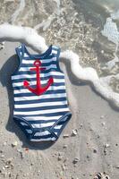AI generated Navy and White Striped Baby Swimsuit with Red Anchor Applique photo