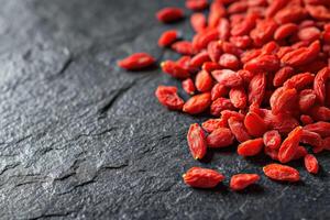 AI generated Fresh Goji berries on dark rough stone table. photo