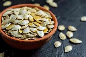 AI generated Pumpkin seeds in a small bowl on black background. photo