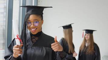 un alegre graduado con un diploma en mano soportes a el Universidad en contra el antecedentes de graduados hablando a cada otro. estudiante intercambiar programa Entre universidades alrededor el mundo video