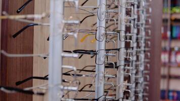 A wide range of different glasses in the store or ophthalmology clinic. Side rack view video