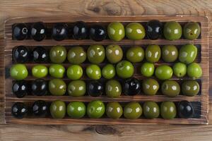 AI generated Set of green and black olives on wooden background. photo