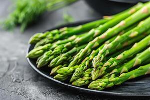 AI generated Vegetables. Green asparagus on the table. photo