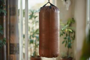 AI generated Brown punching bag hanging in room. Sport, active lifestyle and healthy concepts. photo