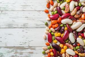 AI generated Mixed dry beans on white wooden board from above. Space for text. photo